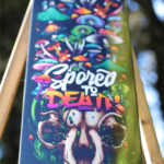 Mushroom skull skateboard wall art with Spored to Death vinyl wrap applied to skateboard deck