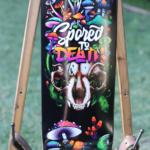 Mushroom skull skateboard wall art with Spored to Death vinyl wrap applied to skateboard deck