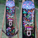 Mushroom skull skateboard wall art with Spored to Death vinyl wrap applied to skateboard deck